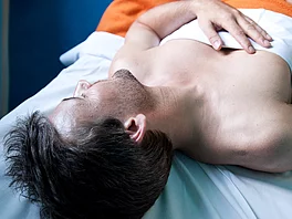 Mann liegt im Ruheraum und schläft im Gasteiner Heilstollen.