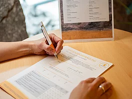 Patientin fuellt Fragebogen aus im Gasteiner Heilstollen.